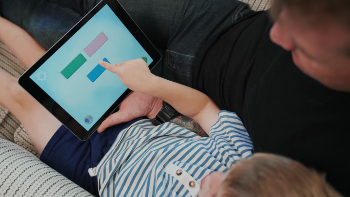 Child using Elkonin tiles in a phonological awareness game